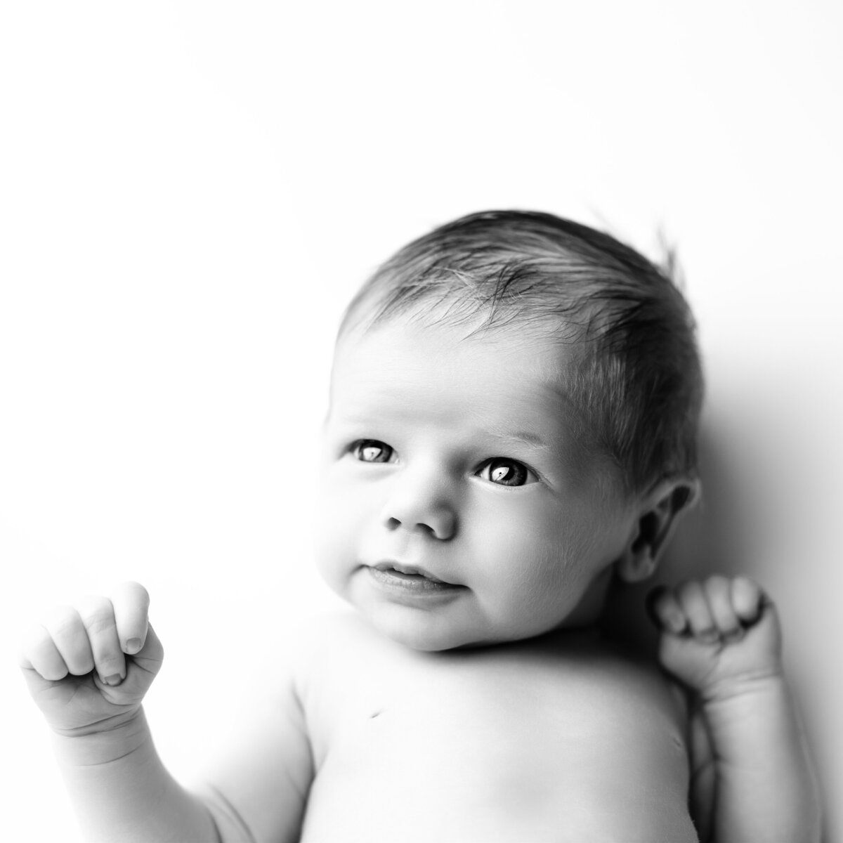 An expressive newborn portrait that brings out the child’s joyful spirit and sense of wonder.