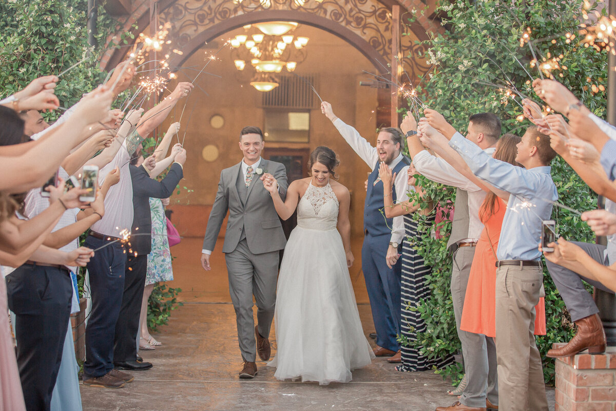 The bride and groom exit while guests  raise their sparklers in a farewell gesture. By  Boulder photographer,  Stephanie Eddy