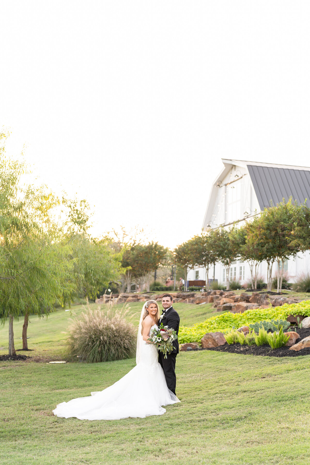 Bride and Groom smiling with bouquet at Springs Wallisville