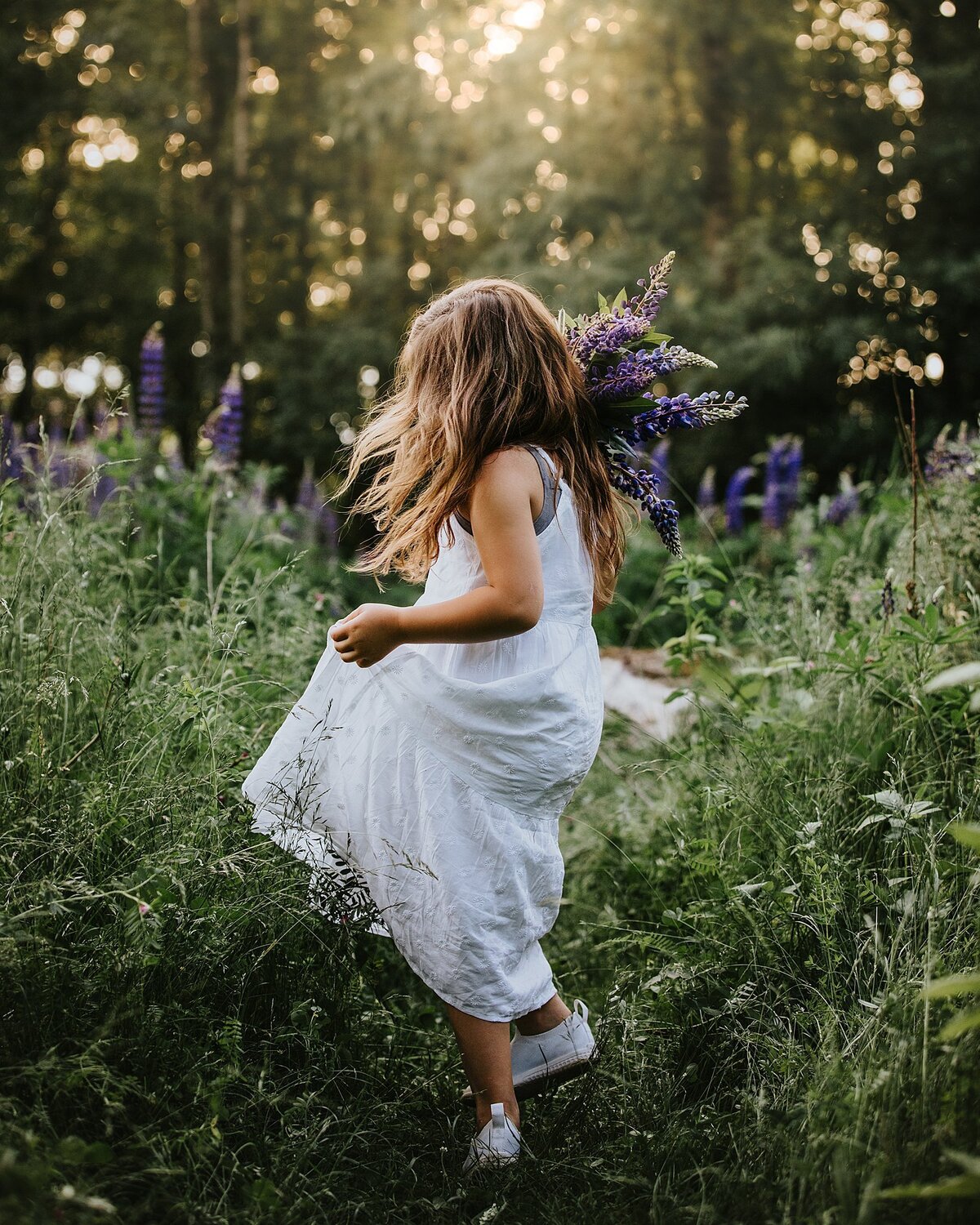 Young girl twirling in Lupins