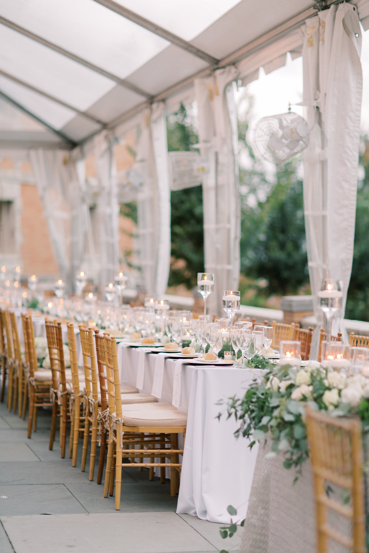 gold chairs and long tables with white table clothes for wedding reception decor