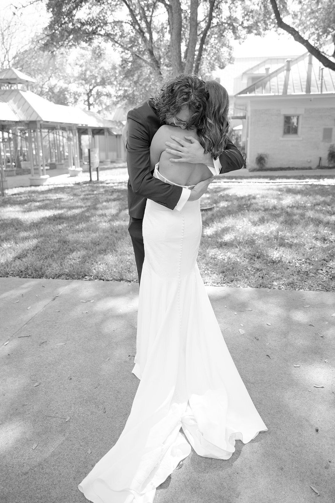 Timeless black and white portrait of bride turning gracefully at San Antonio luxury venue