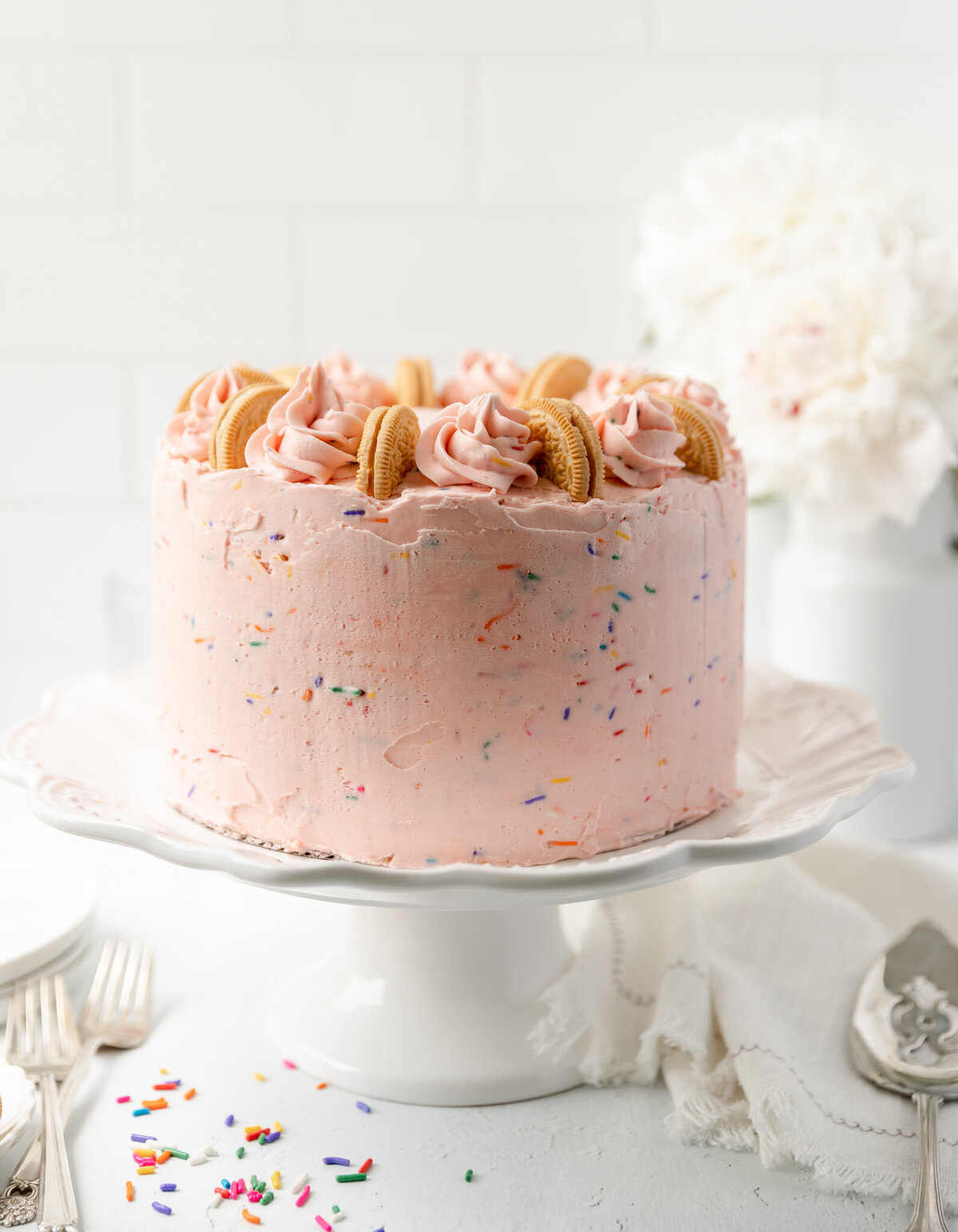 a cake decorated with pink frosting and sprinkles