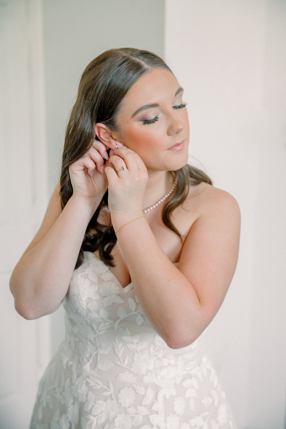 Three Oaks Manor Wedding | bride adjusts earring as she's getting ready