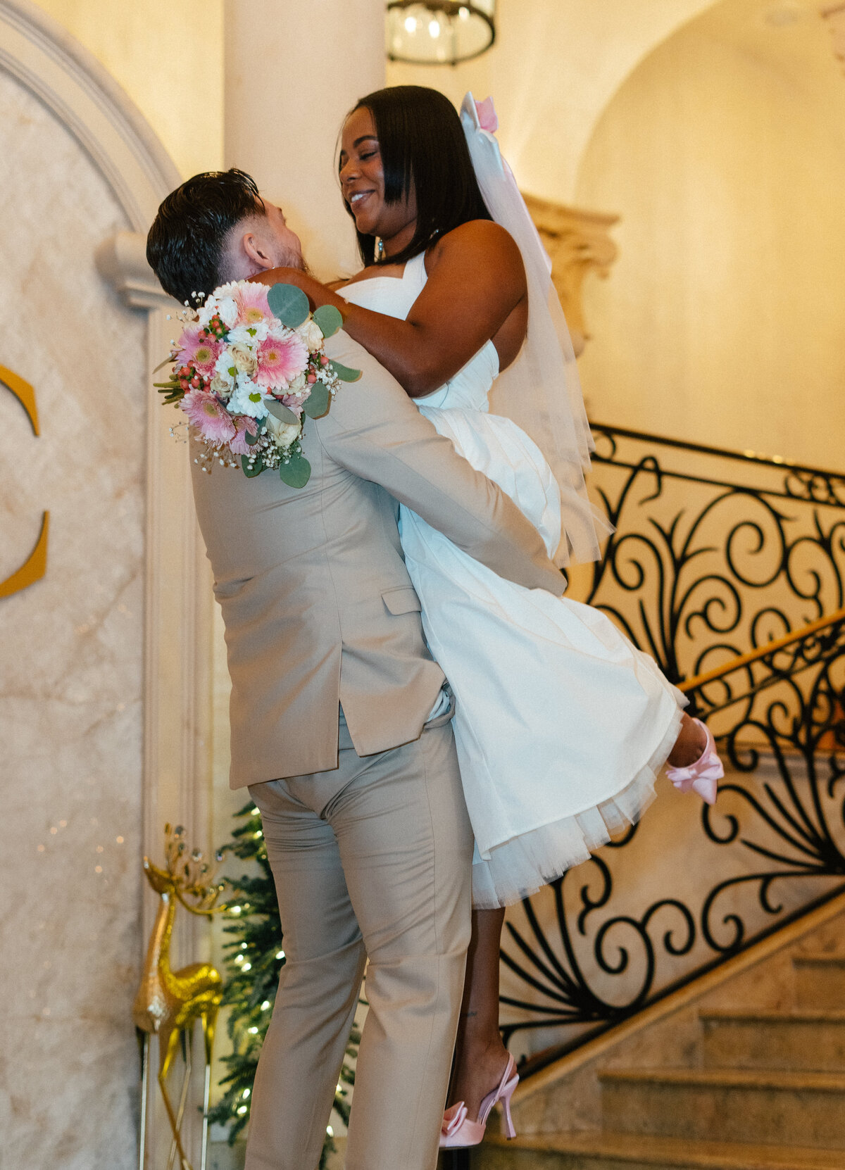 groom lifts up his bride at the stirling club in las vegas, nv
