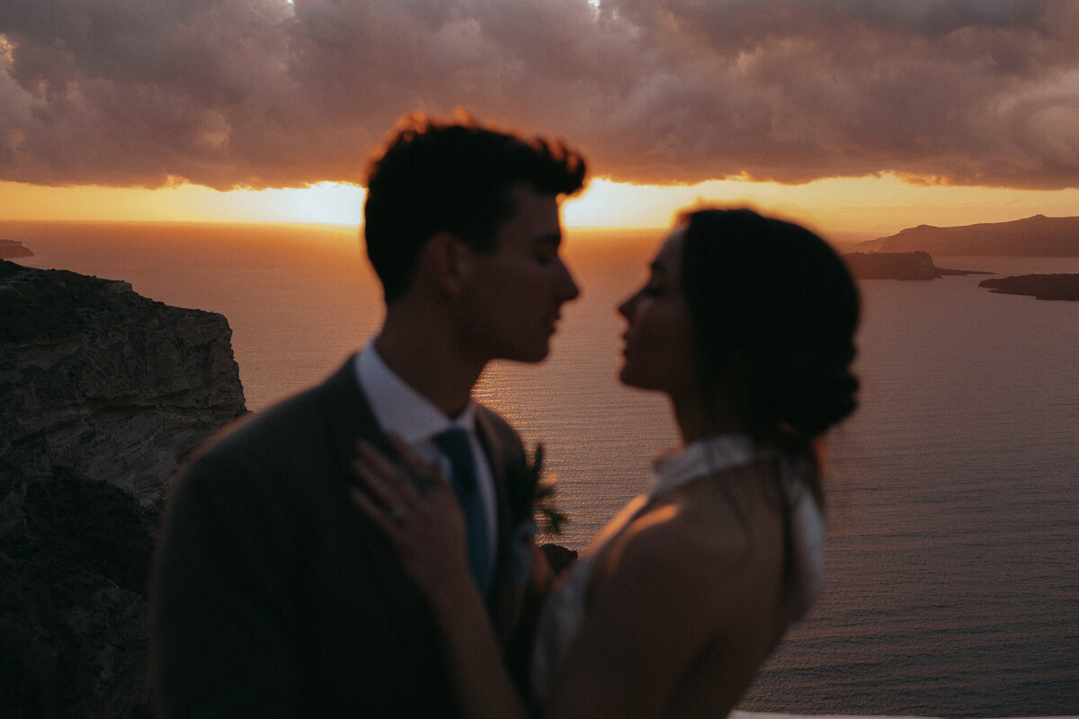 couple at sunset in oia greece