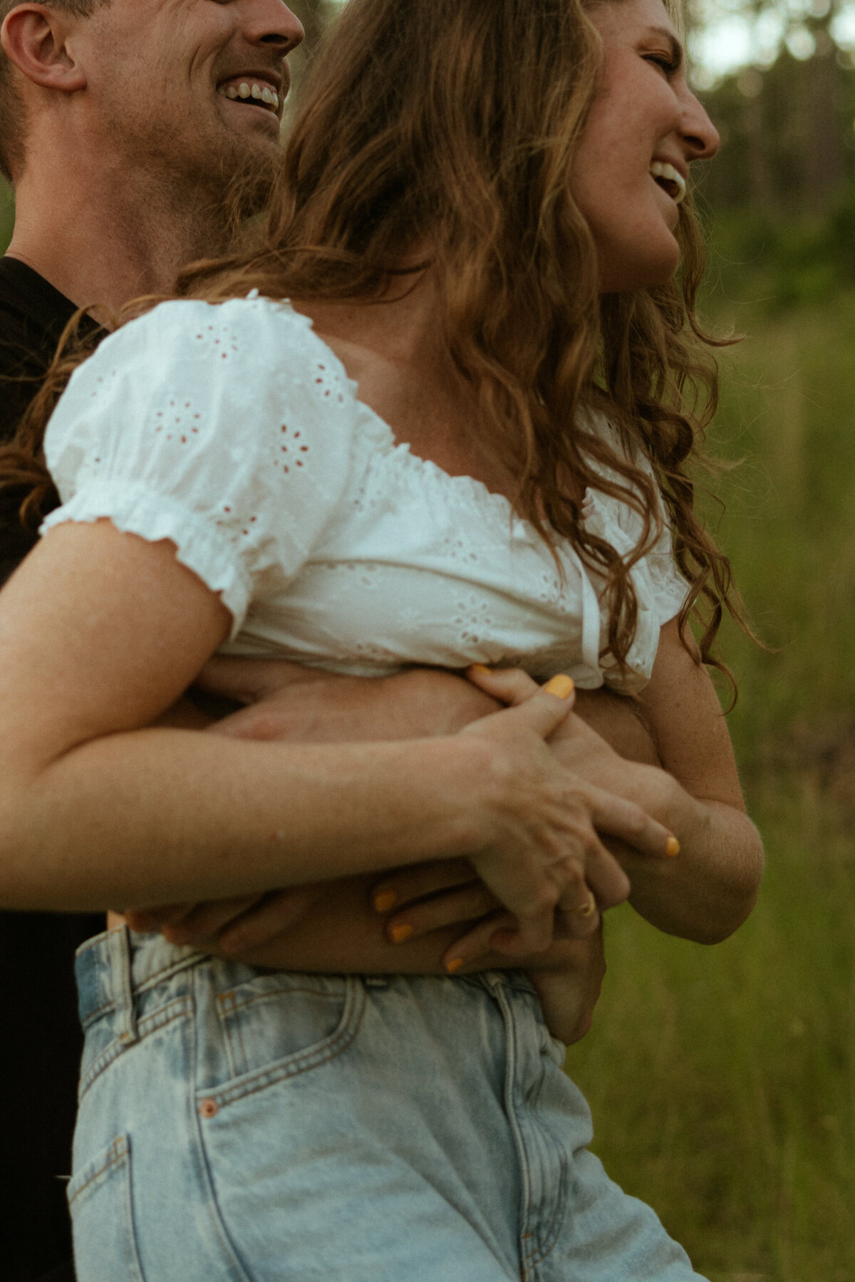 Couple posing for portraits in a forest.
