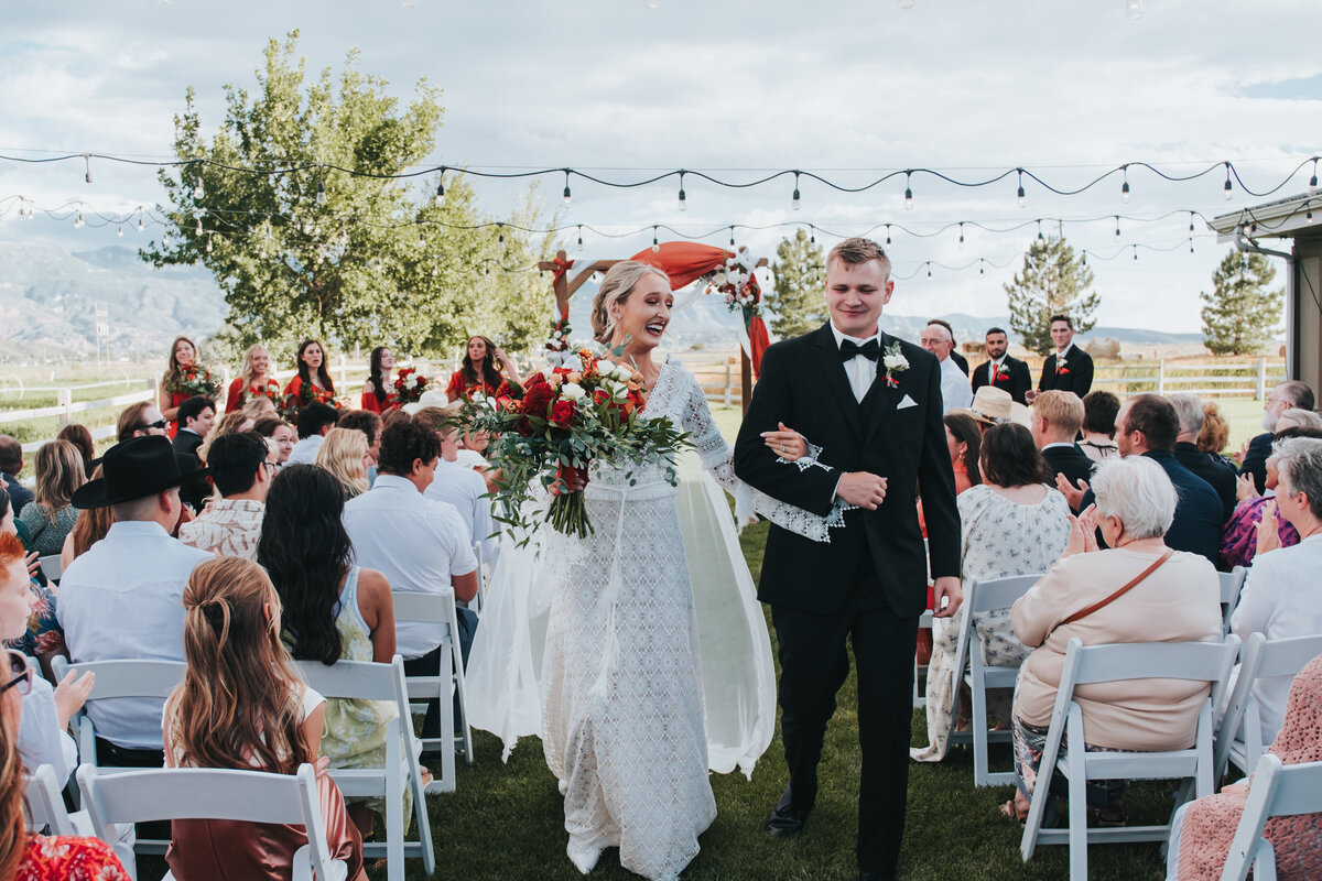 Couple walking back up the aisle after the ceremony
