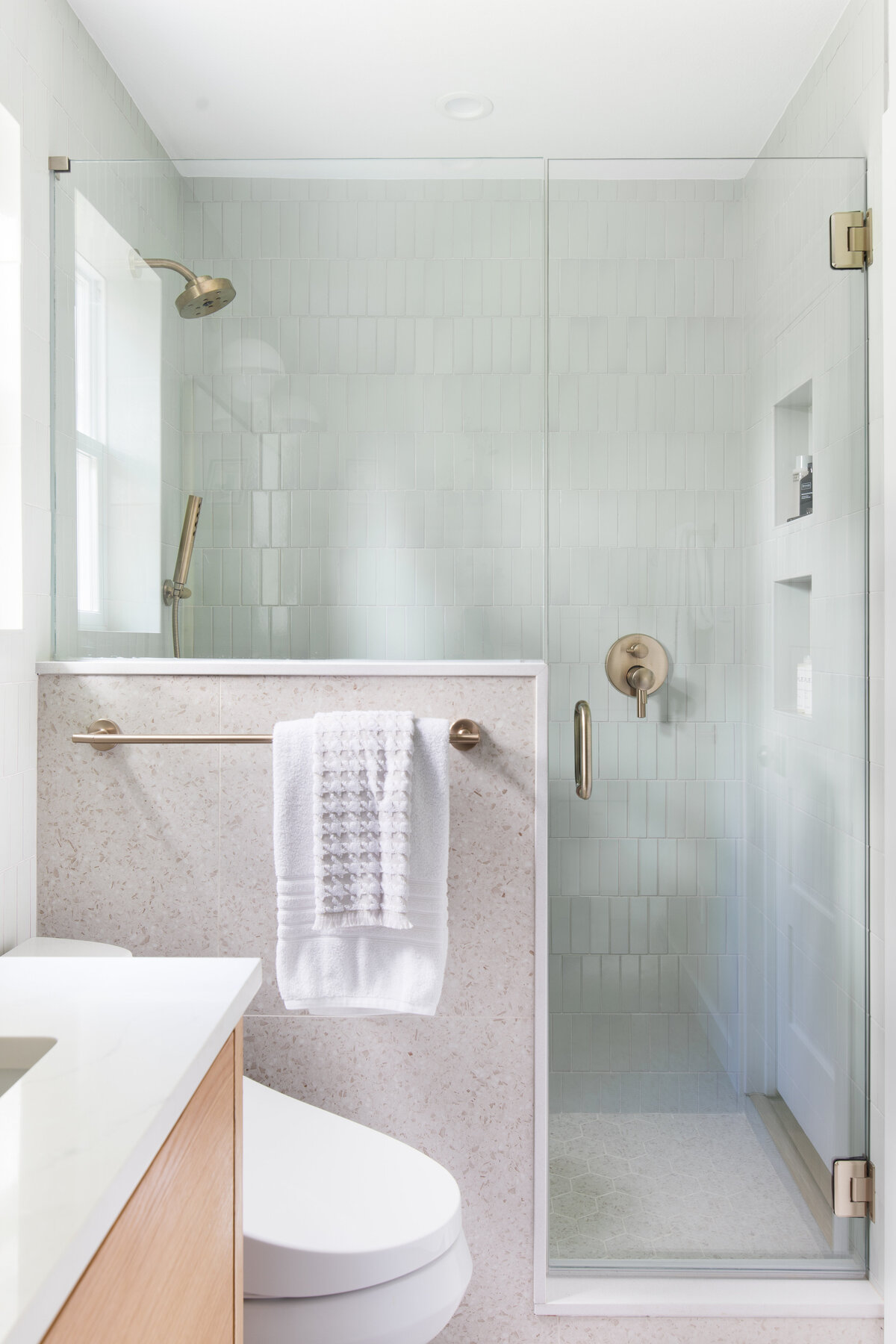 hello-home-luxury-bathroom-design-shower-with-niche-stone-curb-cap-austin-vertical-offset-tile-6