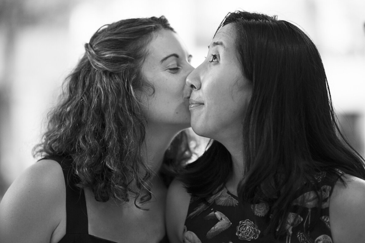 A person kissing their partner's cheek