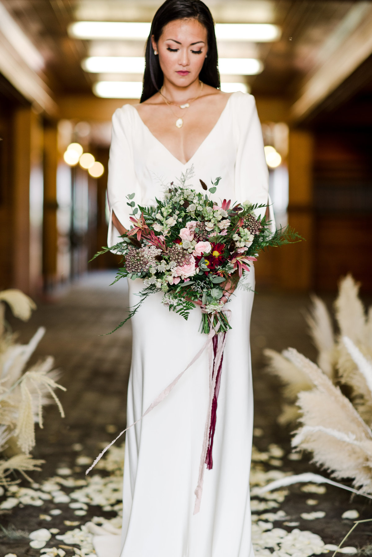 Bride with bouquet in barn at stableview in aiken sc