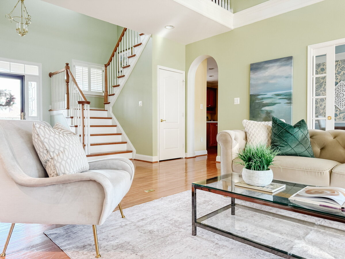 Living area with stairs and green accents
