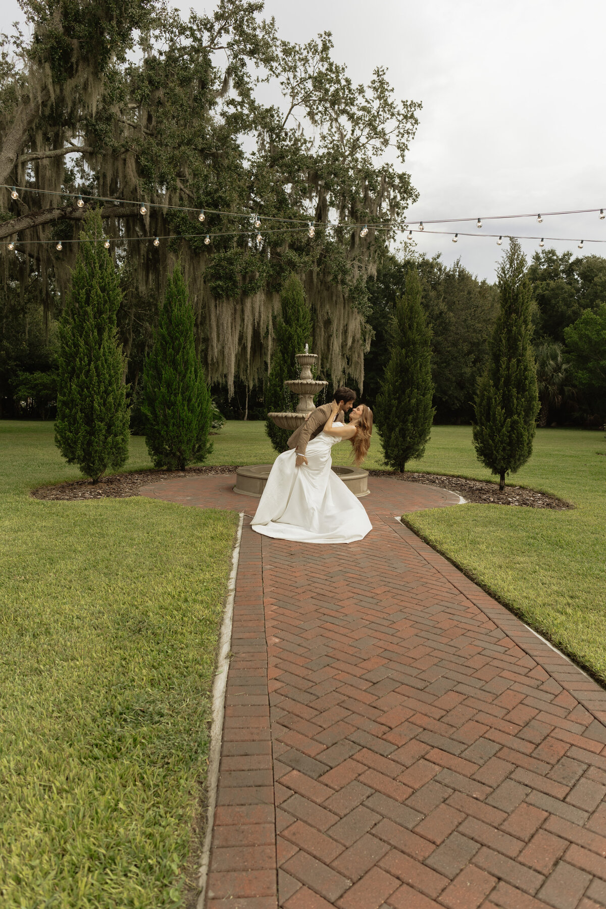 Romantic backyard wedding at The Palm Mansion in Umatilla, Florida with lush palm trees and floral arch
