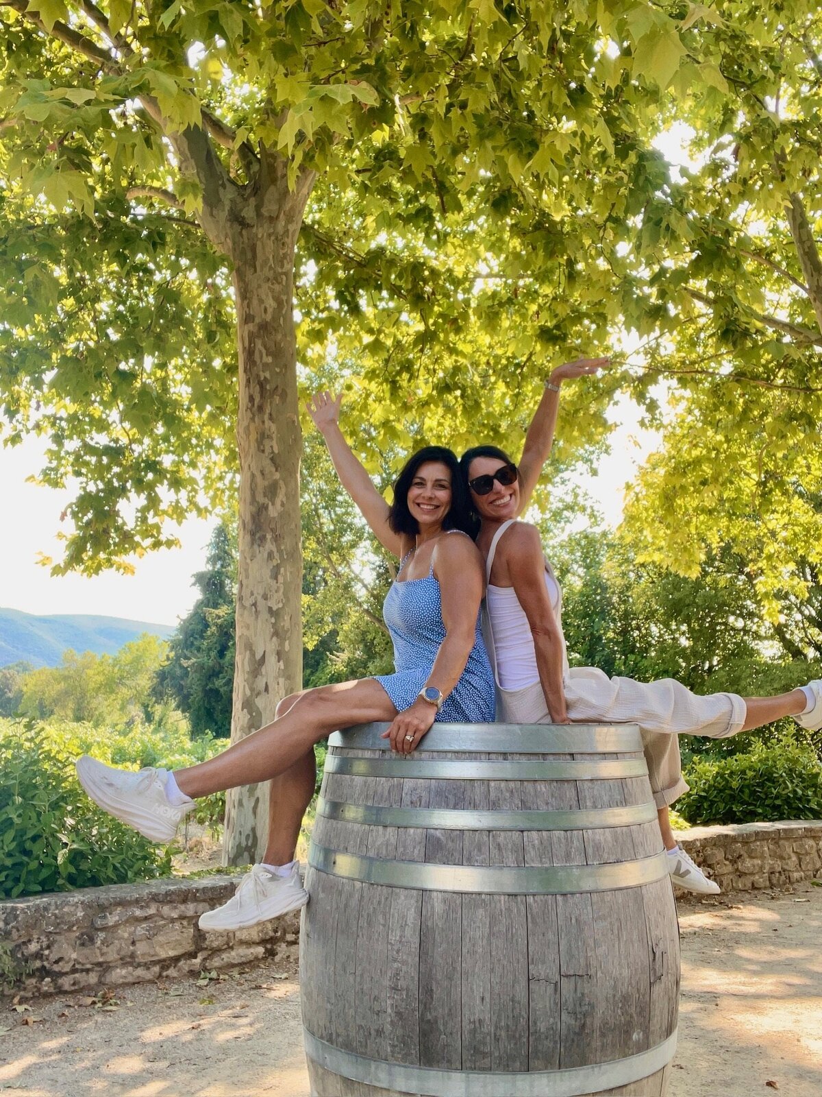 daree and scotta on wine barrel hands up