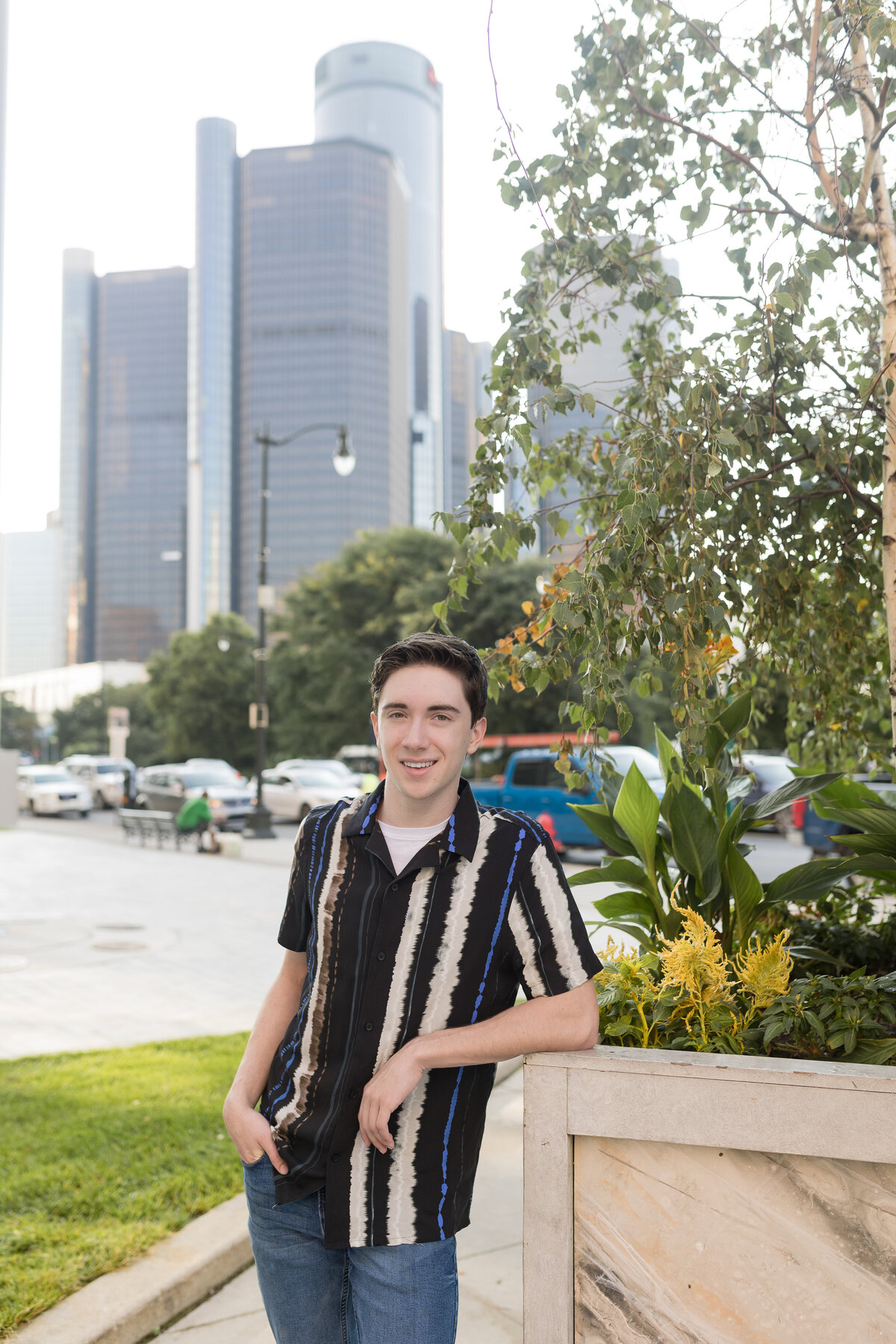 High School senior boy posing for senior photos in Downtown Detroit mi