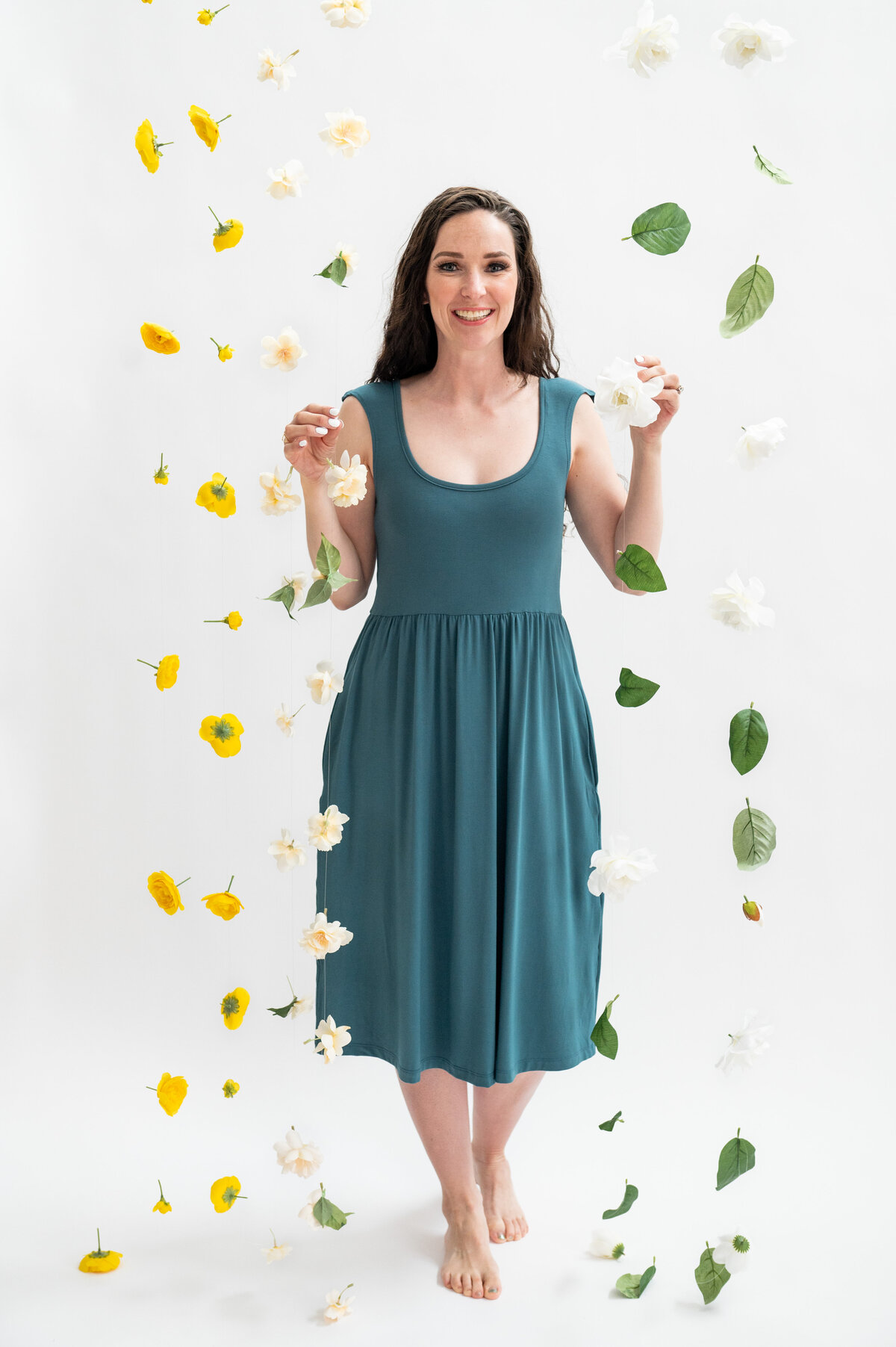 Listing photo of woman in blue tea length dress surrounded by flowers