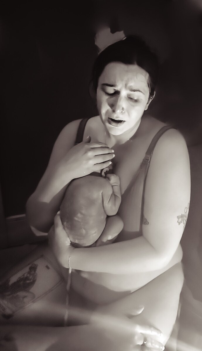 an Edmonton mom holding her baby after giving birth