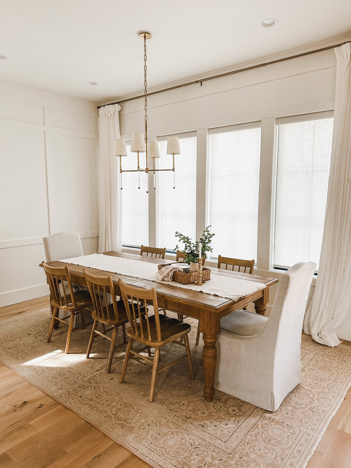 The cozy dining room is tucked in next to the kitchen and features large windows that run almost from the floor to the ceiling