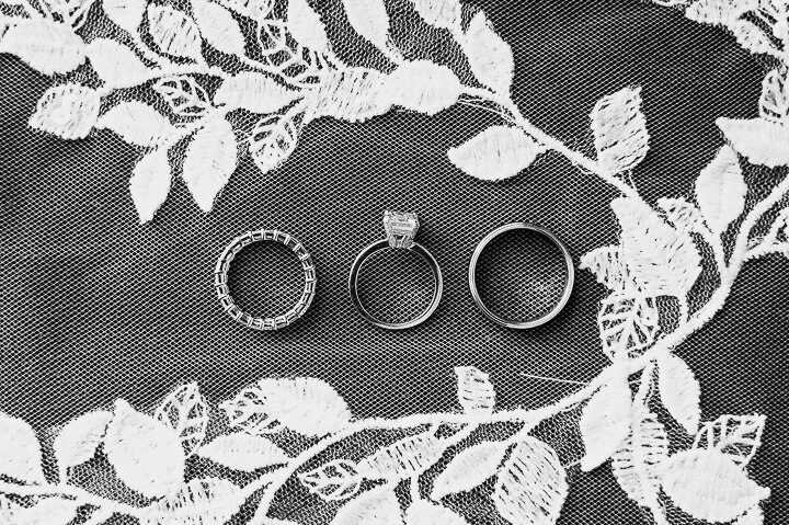 wedding rings laying on top of lace
