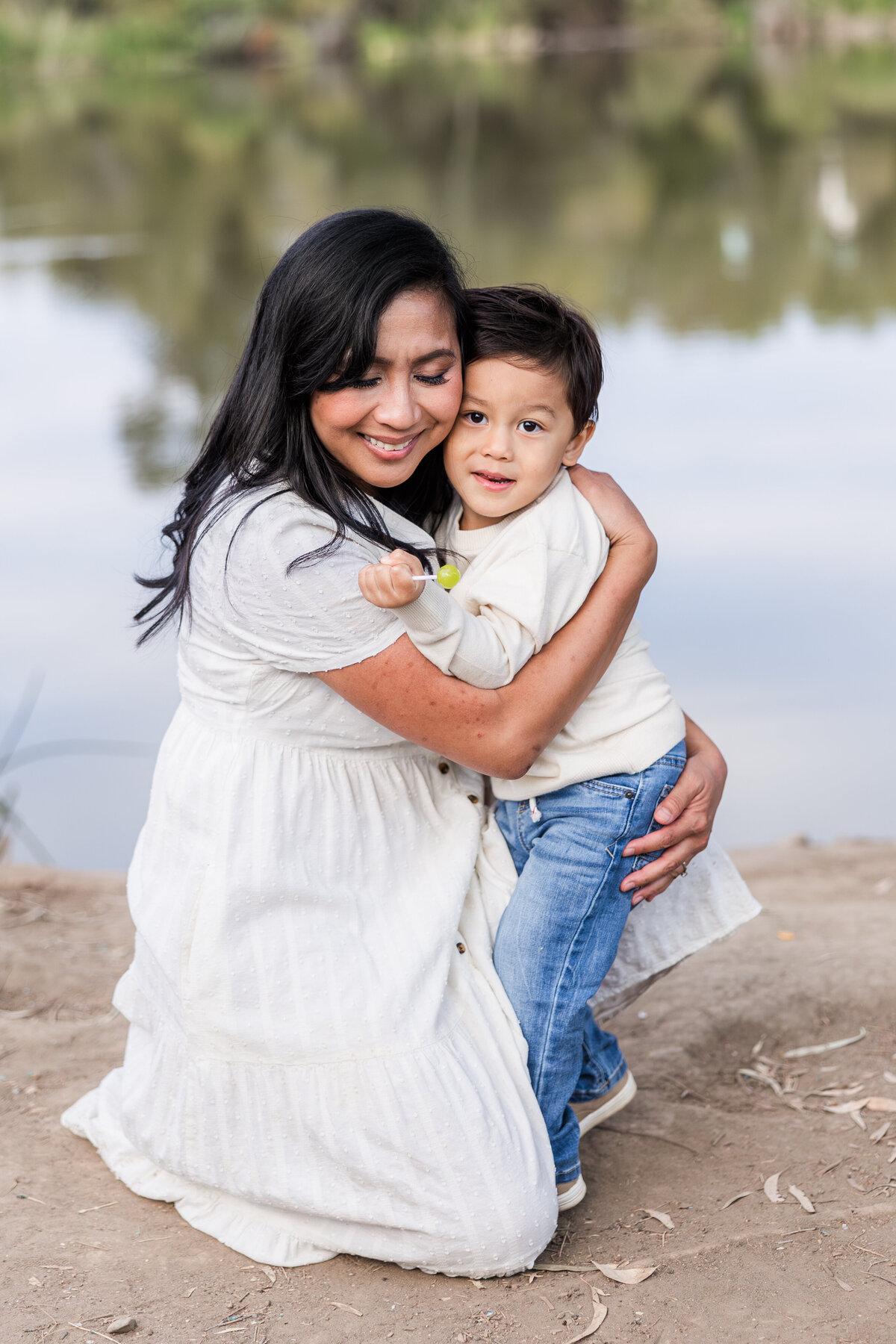 mother hugging son by morrison pond san diego