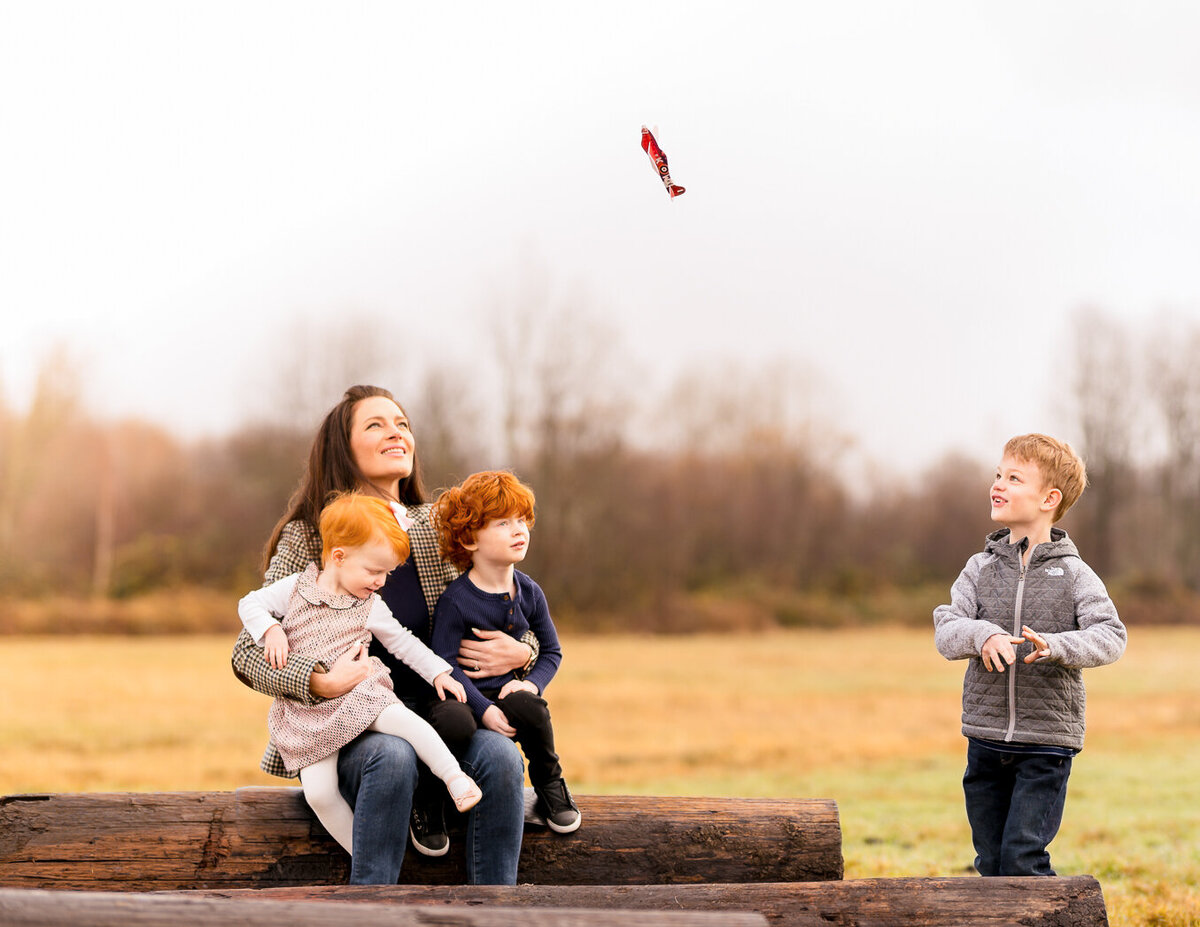 family-photoshoot-boy-flying-airplane-simple-pleasures