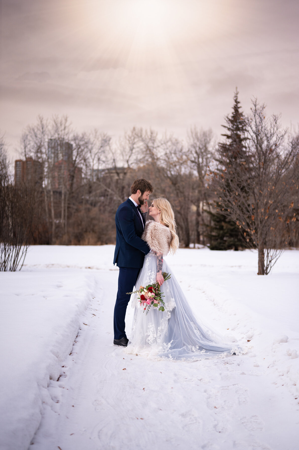 bride and groom in snowy winter field