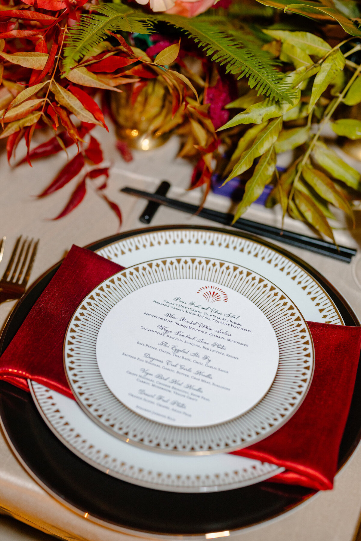 Circular menus on place setting with red napkins