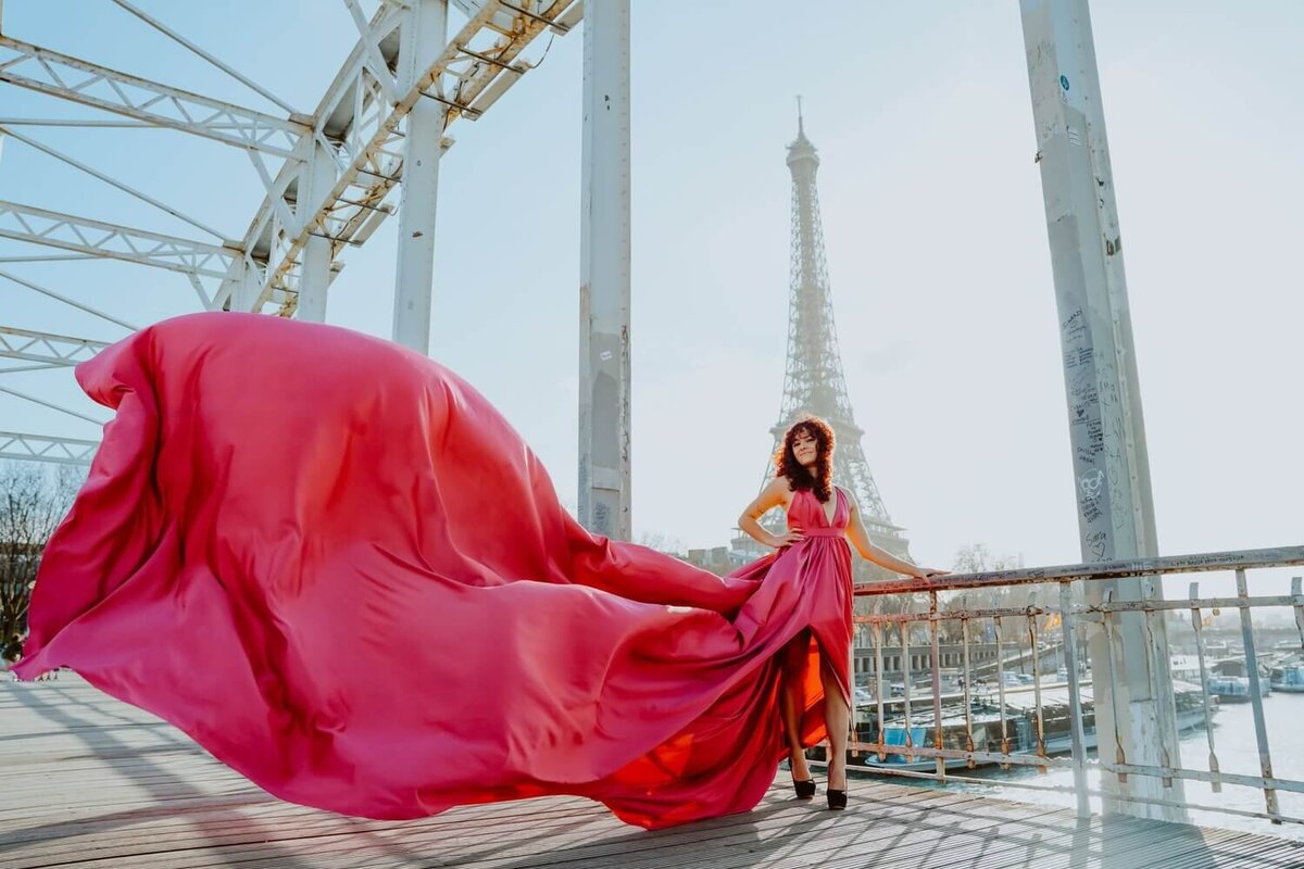 women having a portrait photoshoot in paris wearing a pink flying dress