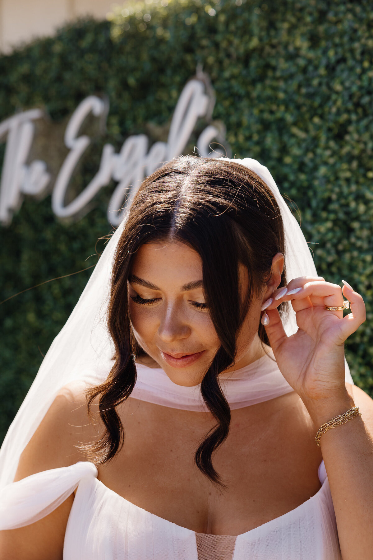 A bride adjusting her earrings