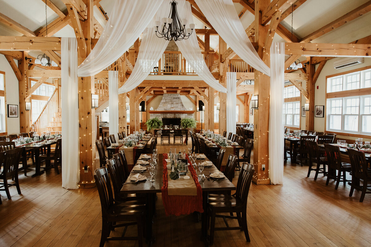 A photo of an empty long table prepared for a wedding reception after the wedding finishes