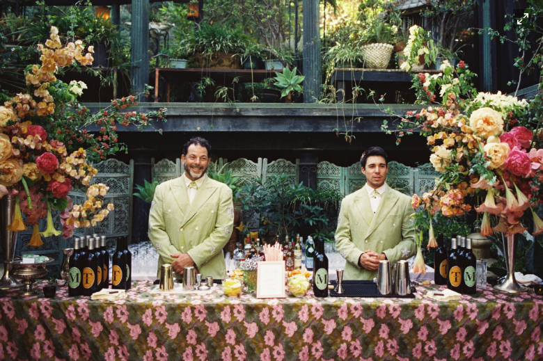Statement floral bar installation with patterned tablecloth and bold colors, cocktail hour inspiration for Airlie Gardens weddings