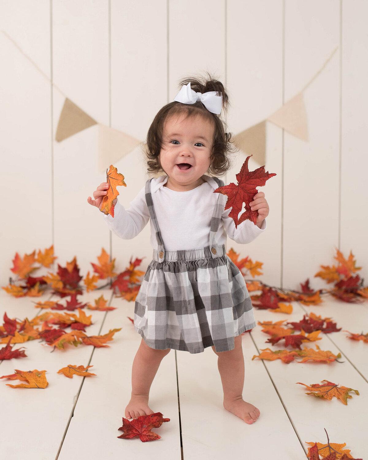 Baby photo in autumn leaves by Laura King, Houston Photographer