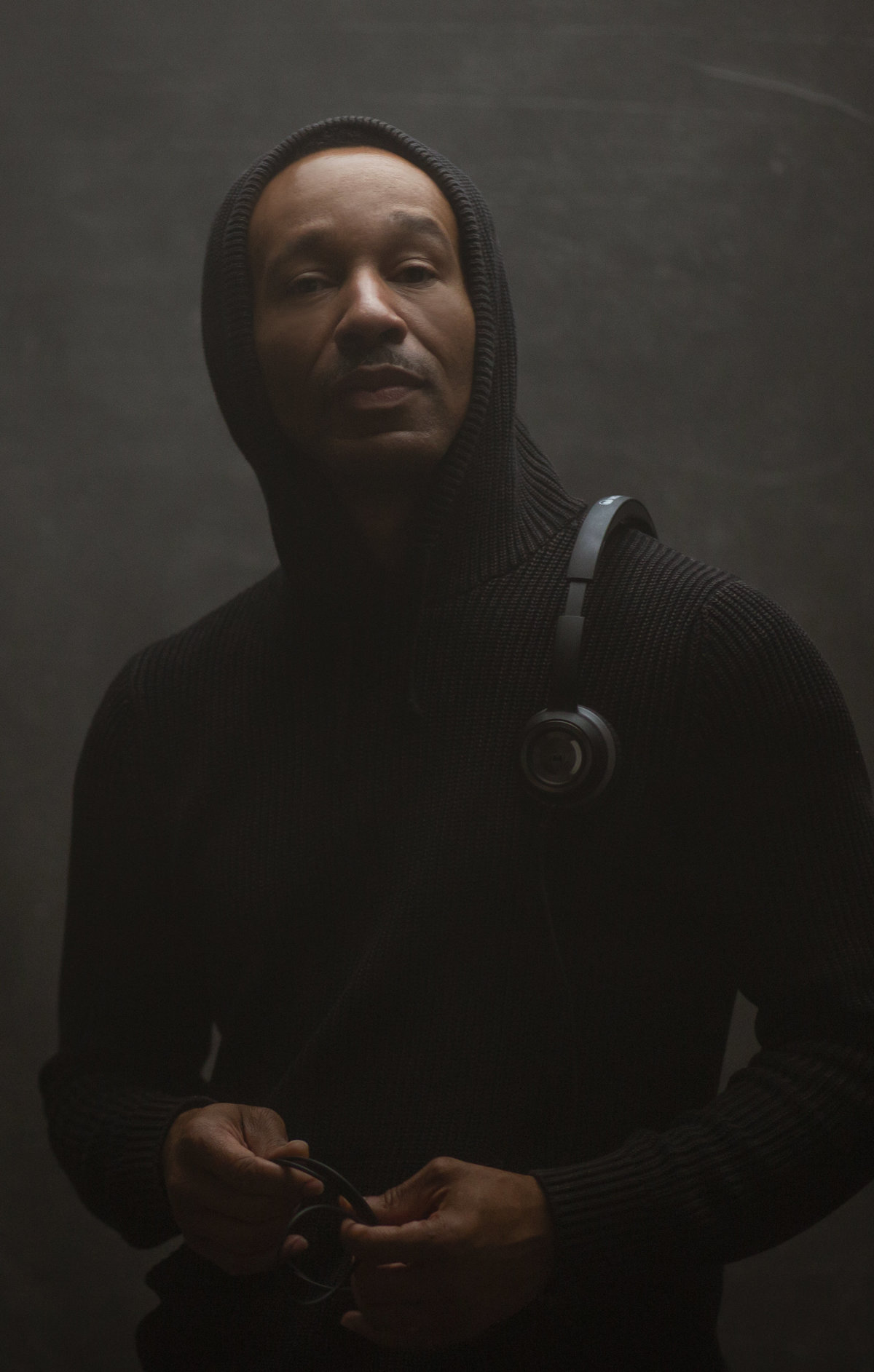 A black African American man poses for a Personal Branding Photograph while carrying headphones for Janel Lee Photography Studios Cincinnati Ohio