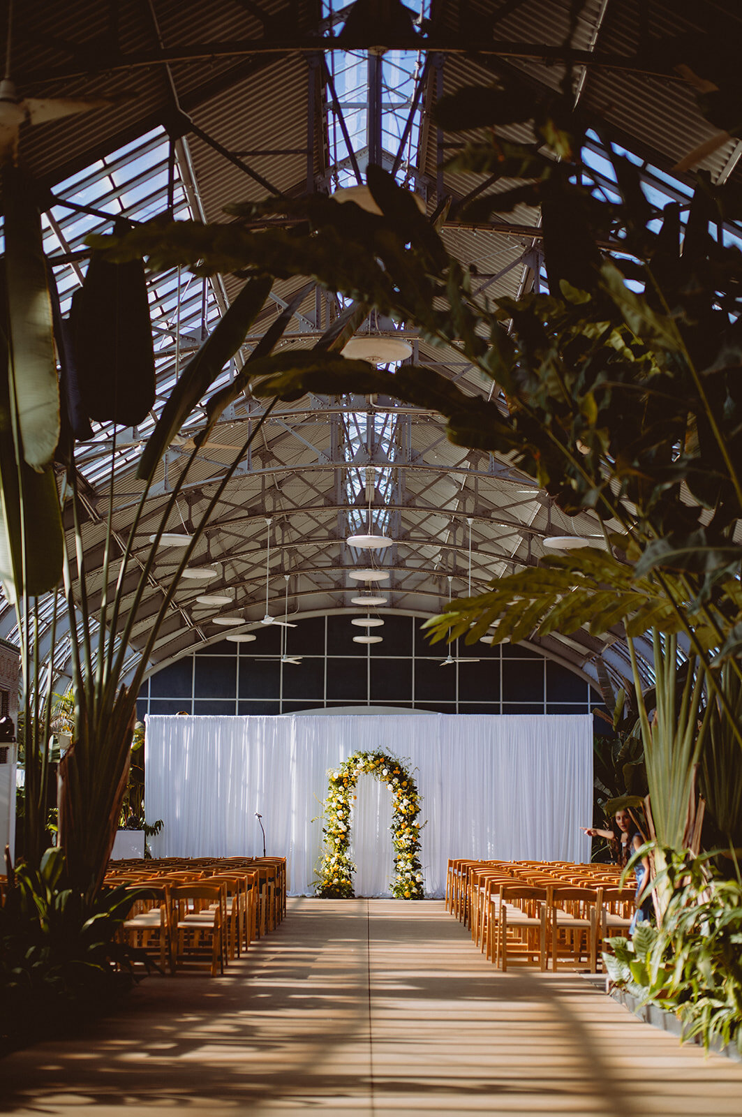 green and yellows wedding arch in conservatory