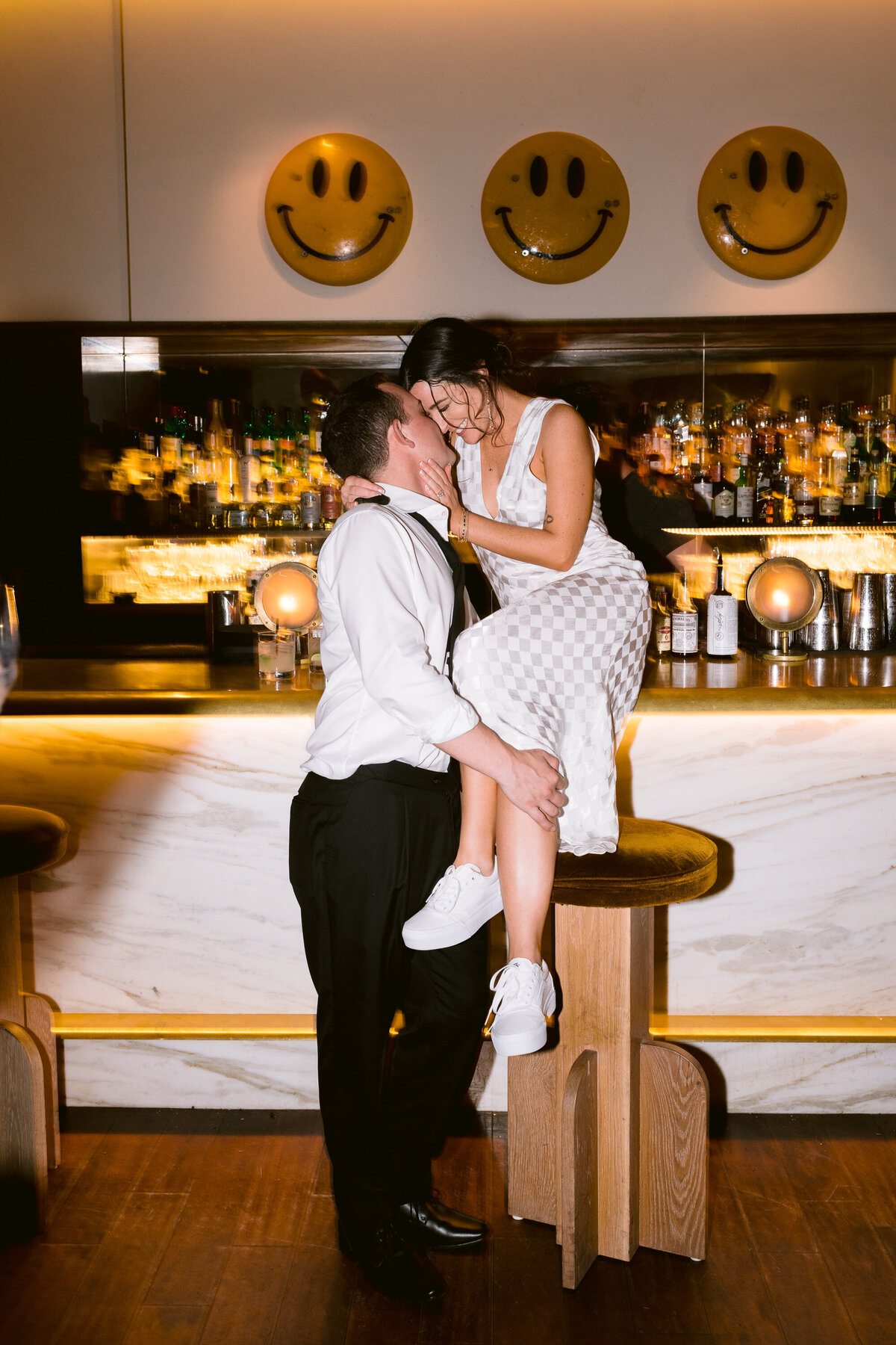 groom and his bride sitting on bar