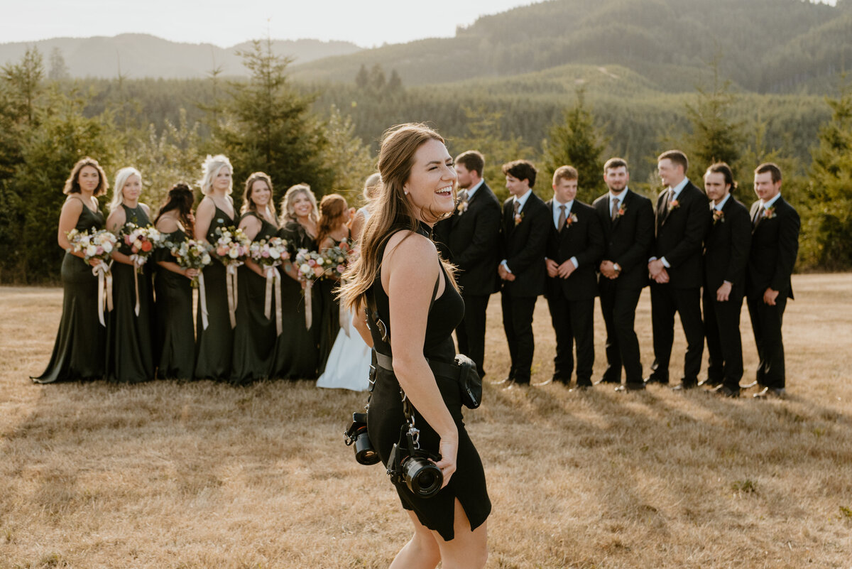 Photographer smiling in front of bridal party