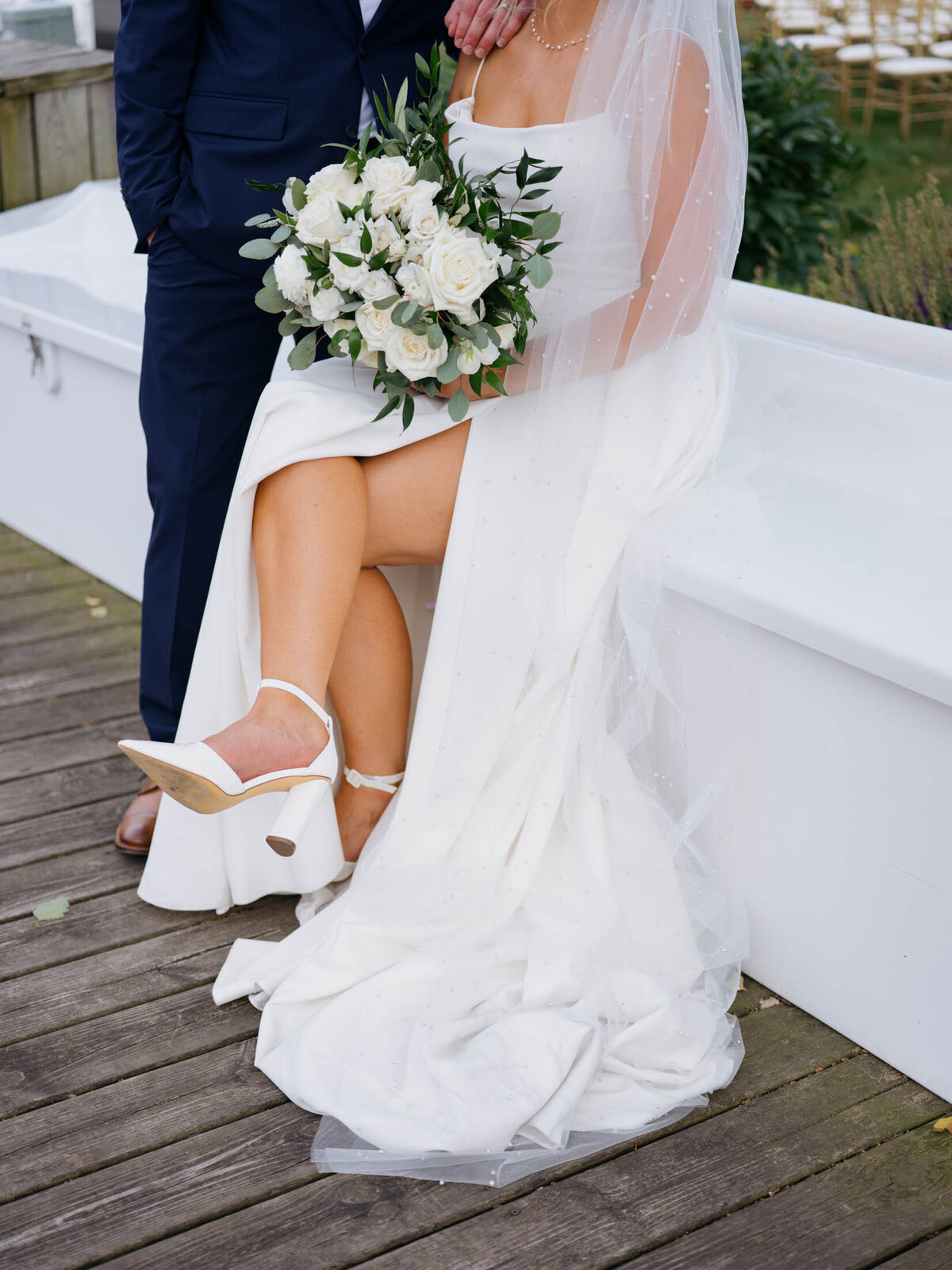 Detail of brides shoes and flowers at Cleveland Yachting Club