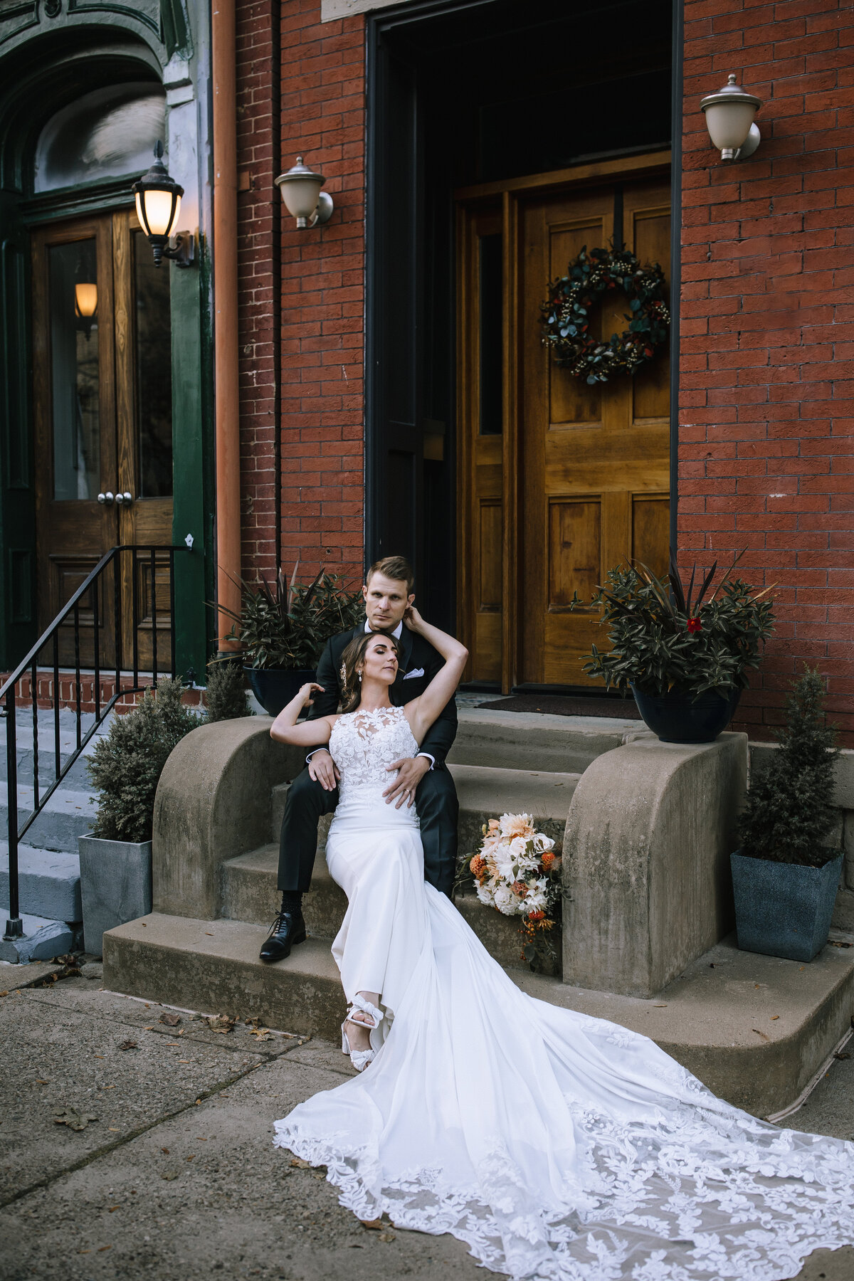 Bride and groom laying on steps at a Priory Grand Hall wedding.