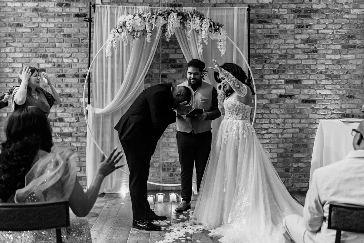storyteller-collective-photo-co-emotional-ceremony-moment-under-arch-surety-hotel-des-moines-iowa