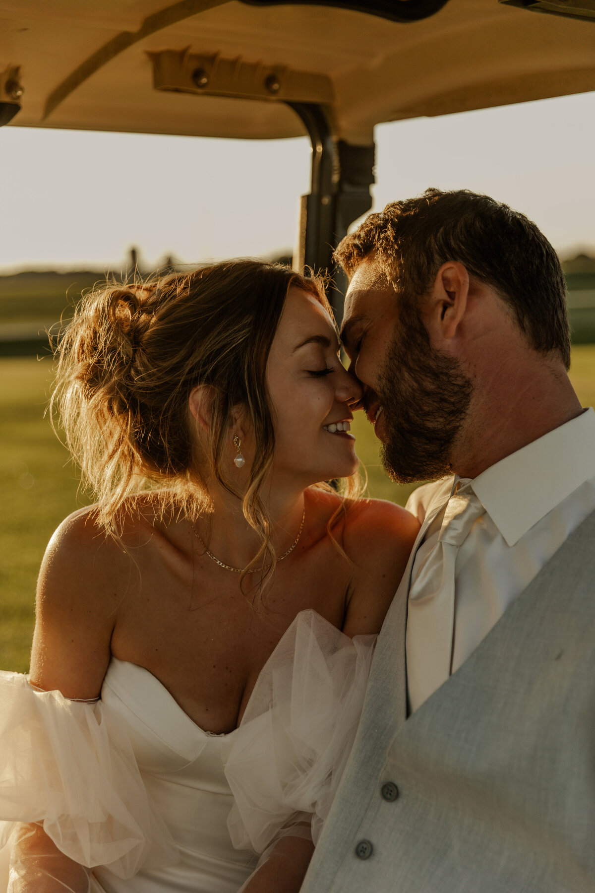 Bride and Groom holding each other on a golf cart in Caledonia, MN 