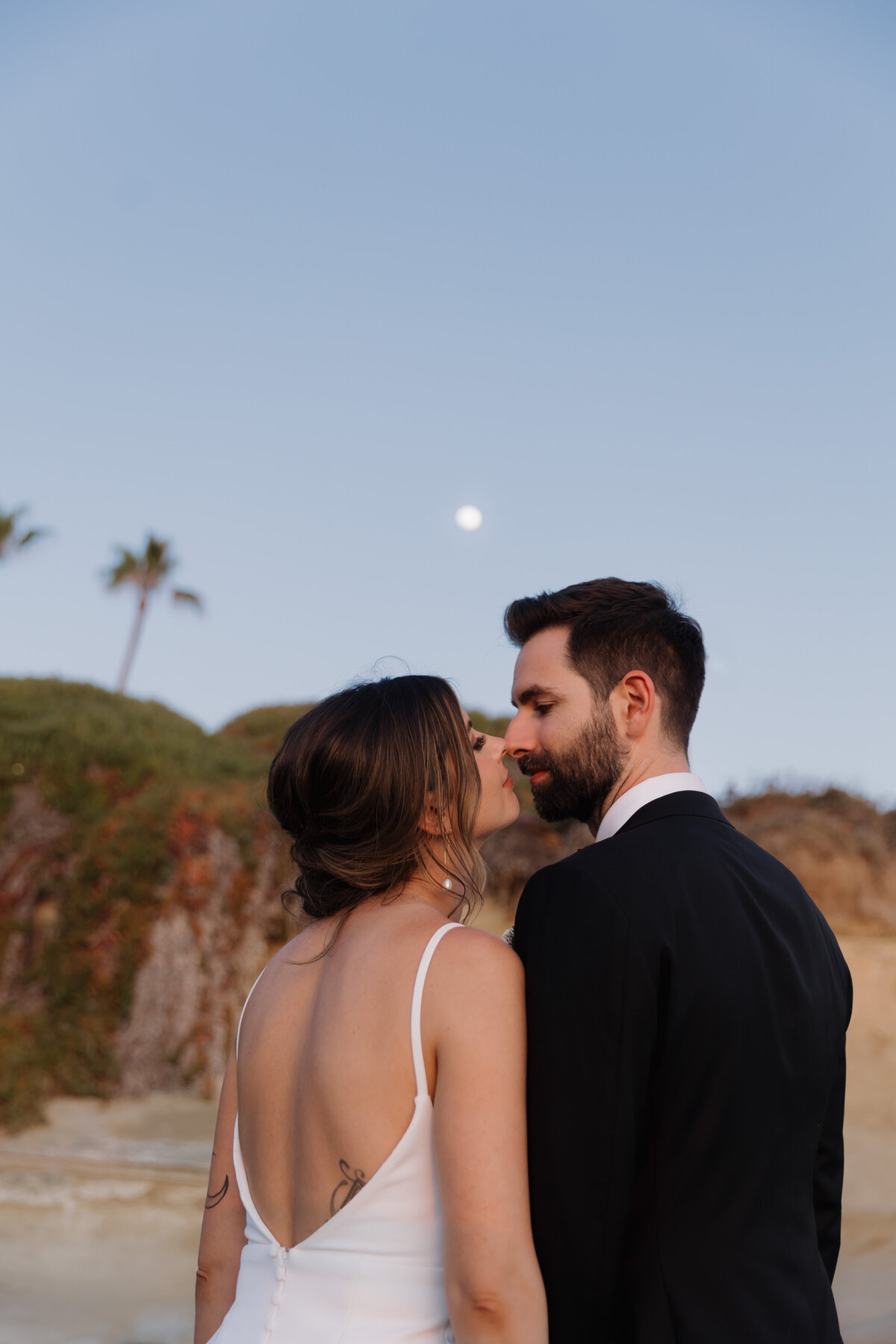 A moody, editorial wedding portrait in La Jolla at dusk, featuring cinematic storytelling and luxury wedding aesthetics.