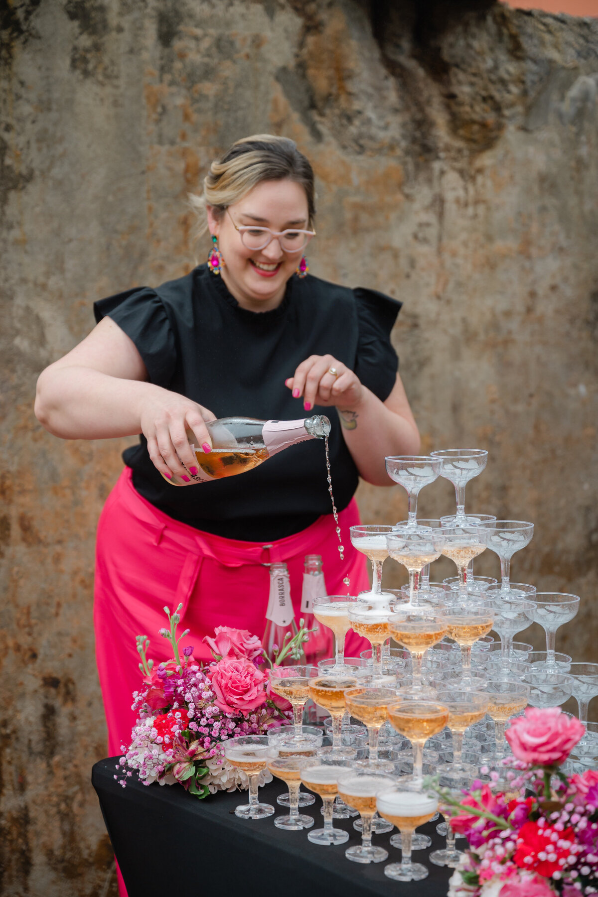 Rachel pouring champagne in champagne tower
