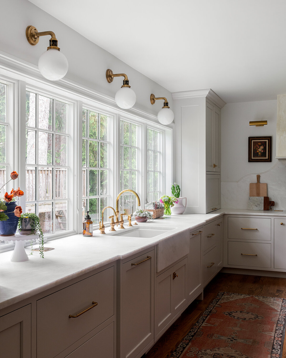 bright white countertop with sink and large windows