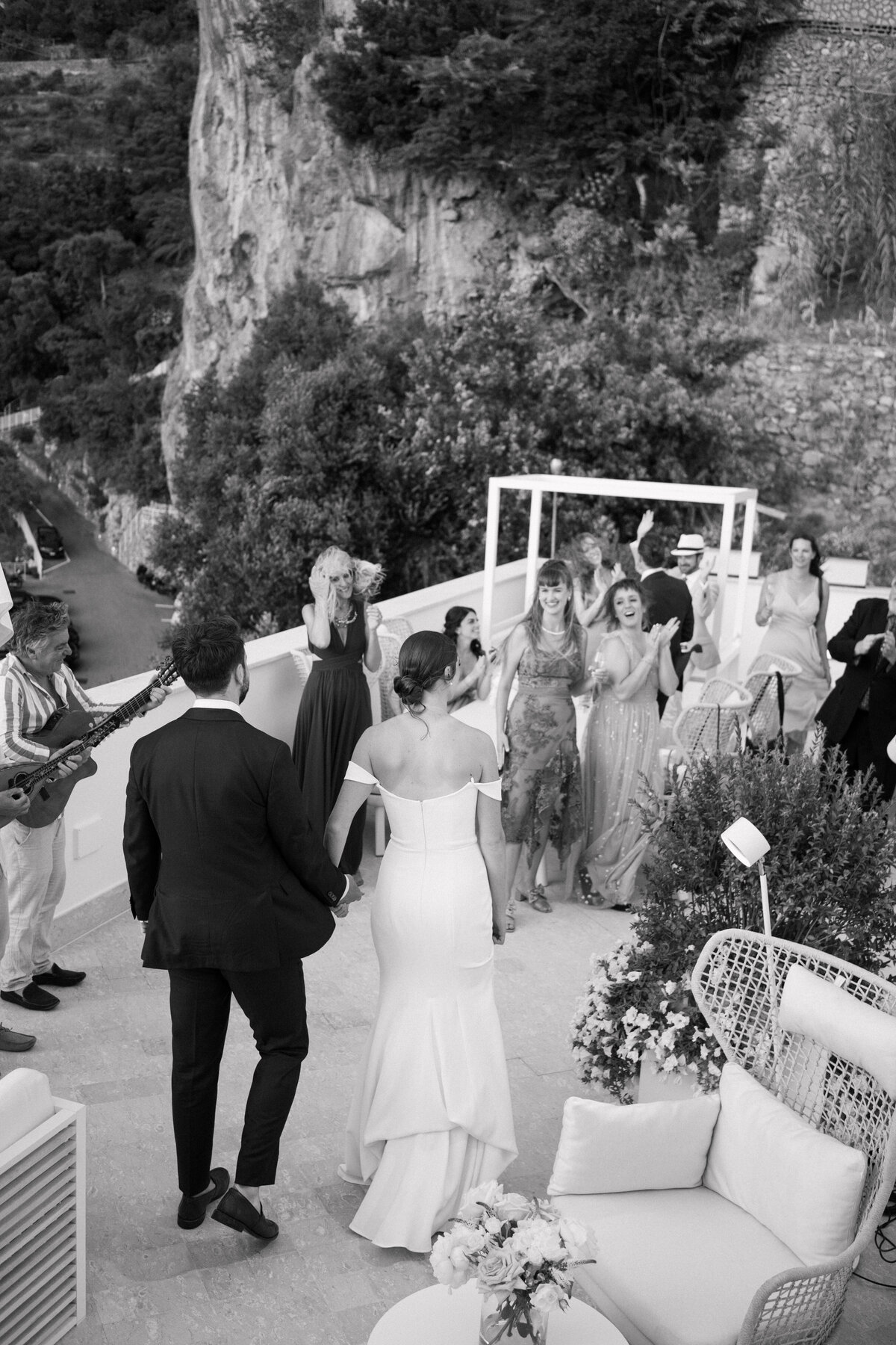 Bride and groom entering the party at Amalfi wedding roof top