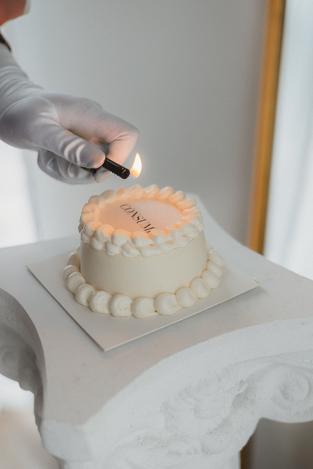 Someone lights a candle for a cake