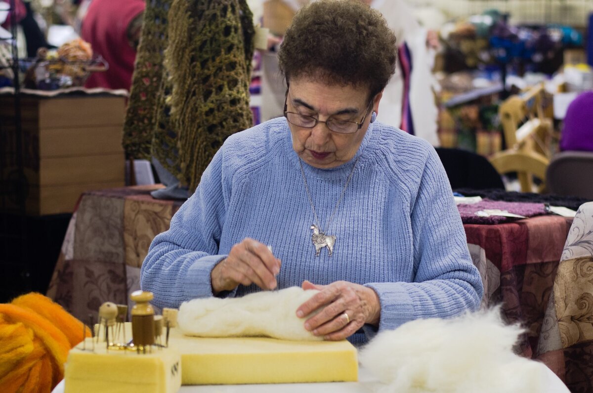 Women felting with alpaca roving