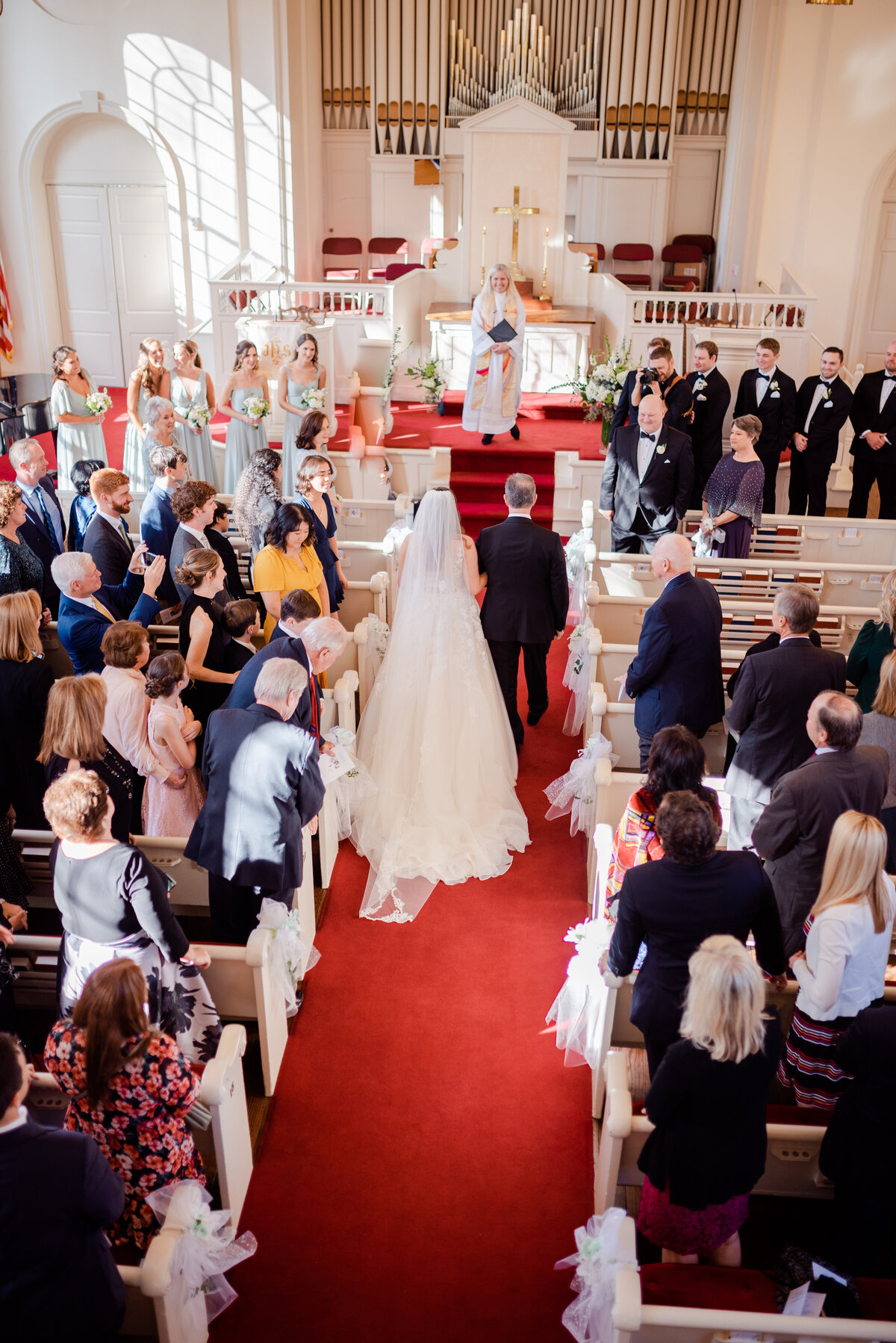 A Father and a Bride walk down the aisle of a church in Fairfield Connecticut.