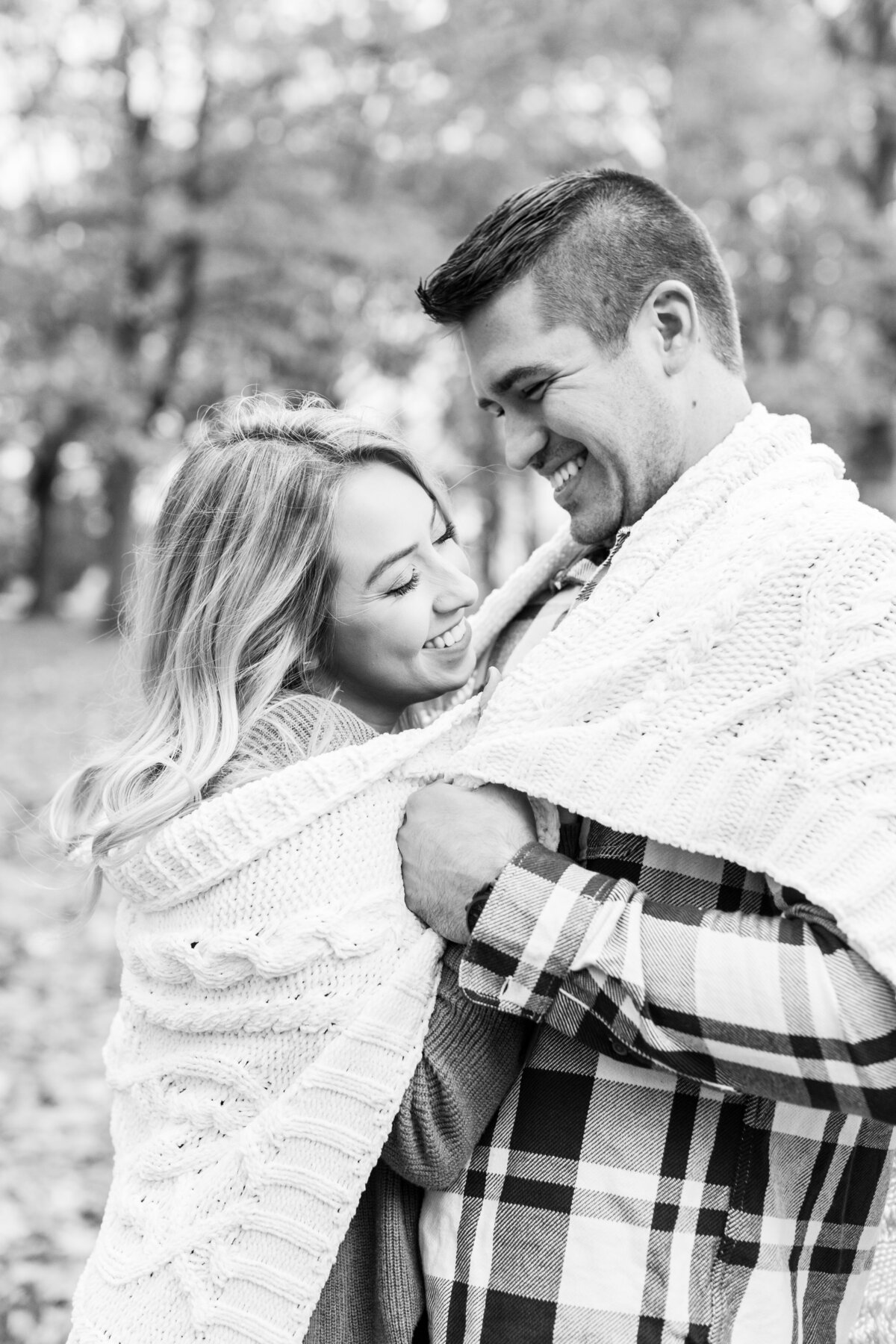 couple wrapped in a blanket in the Fall