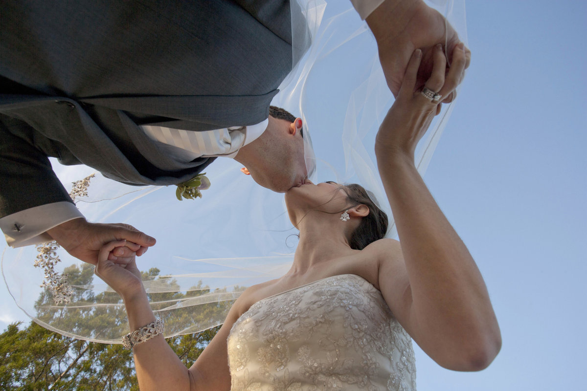 monroe_photographer_a_focused_life_photography_wedding_athens_bride_groom_kissing_veil