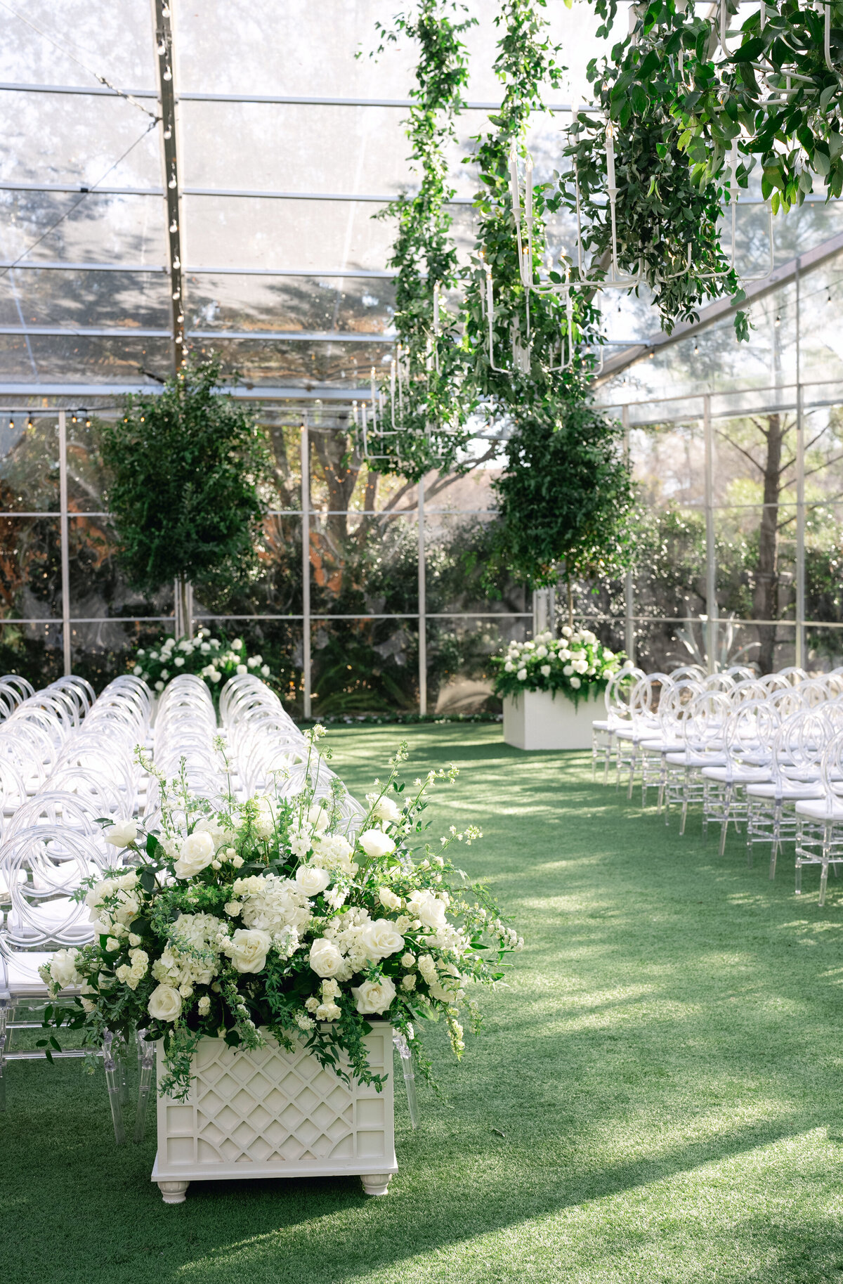 Tented wedding ceremony at Hotel Drover, with all white and green flowers and luxury details